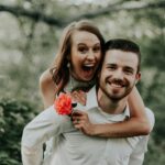 woman riding on back of man