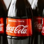 Close-up shot of Coca-Cola bottles highlighting the iconic red label and branding.