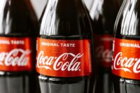 Close-up shot of Coca-Cola bottles highlighting the iconic red label and branding.