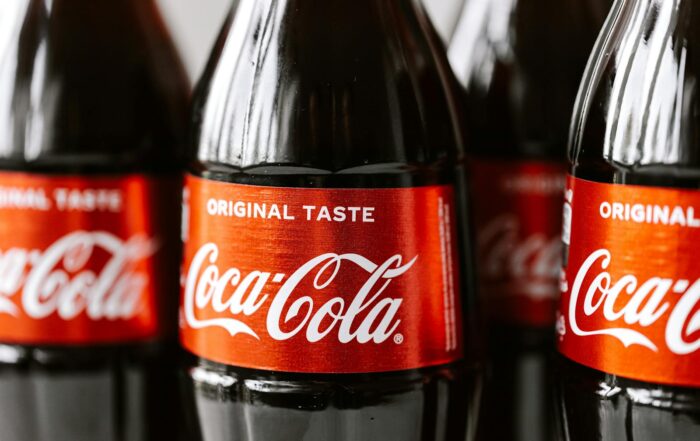 Close-up shot of Coca-Cola bottles highlighting the iconic red label and branding.