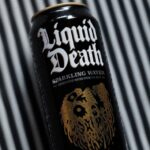 a can of liquid sitting on top of a table