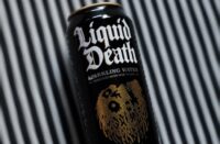 a can of liquid sitting on top of a table