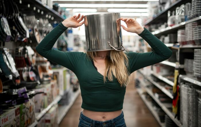 woman in blue long sleeve shirt holding stainless steel mug