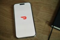 A cell phone sitting on top of a wooden table