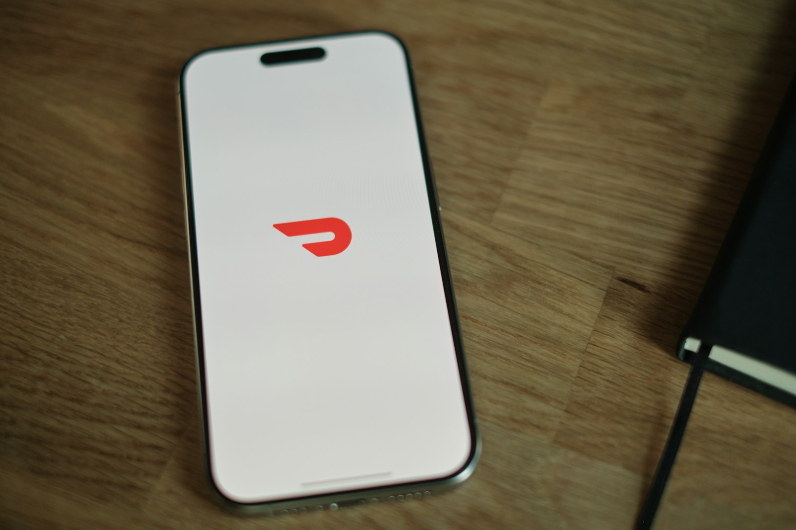 A cell phone sitting on top of a wooden table