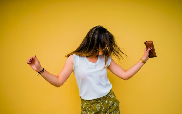 woman standing near yellow wall